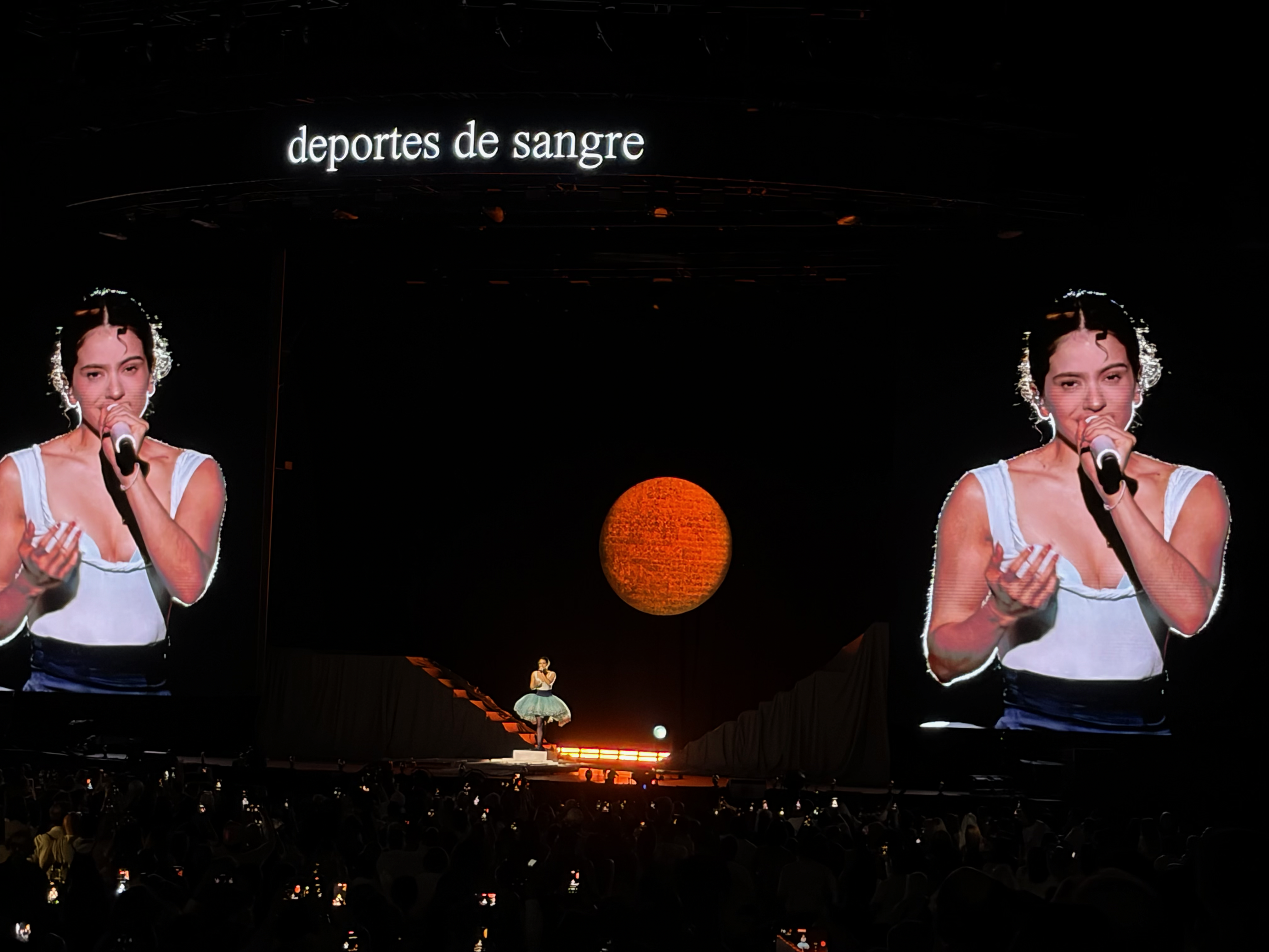 view of the stage with giant video screens showing Rosalía singing at the Coliseo in San Juan, PR, Sept 3 2026